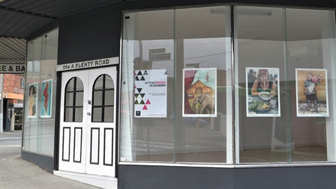 Artwork in windows of a vacant shop