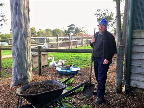 Person standing with wheelbarrow