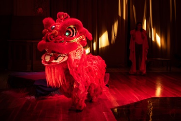 A large red Chinese dragon with green-glowing eyes.