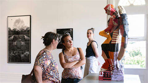 Two people in a conversation in an art gallery