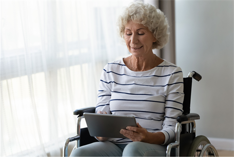 Lady using tablet in wheelchair