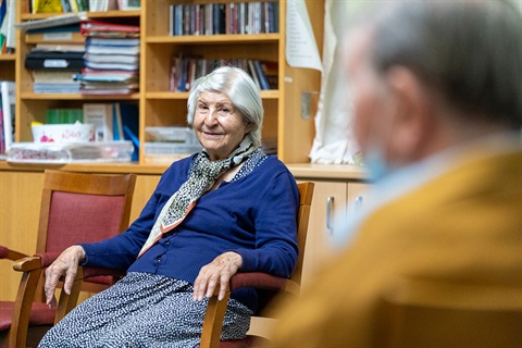 an old lady sitting on a chair