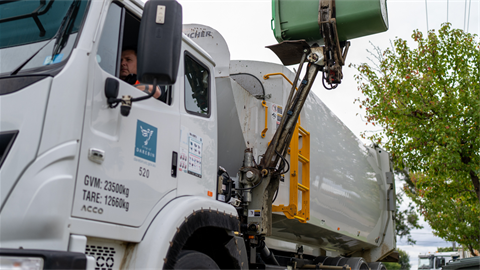 Garbage truck emptying bin