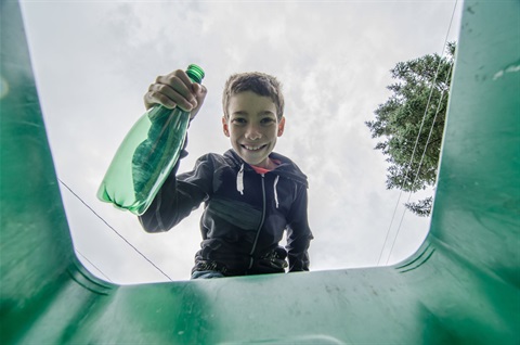 A kid holding a bottle