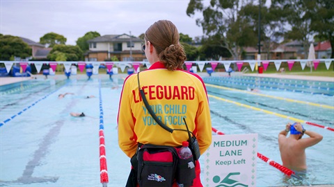 Lifeguard watching swimmers in the NARC outdoor pool