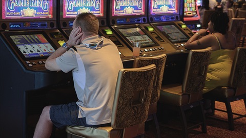 Man bored sitting at poker machines