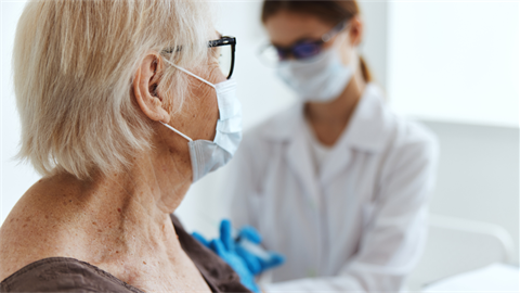 Nurse giving patient vaccine