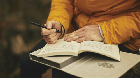 person sitting writing