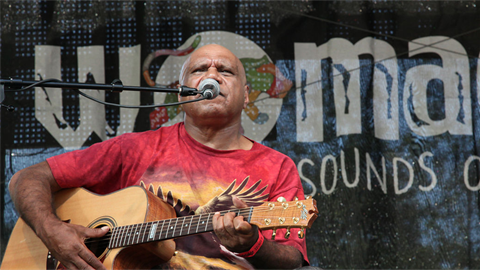 Uncle Archie Roach playing guitar