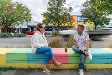 Two people sitting on a bench