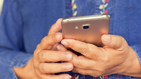 A person operating a mobile phone device