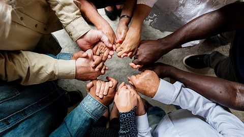 People holding hands in a circle