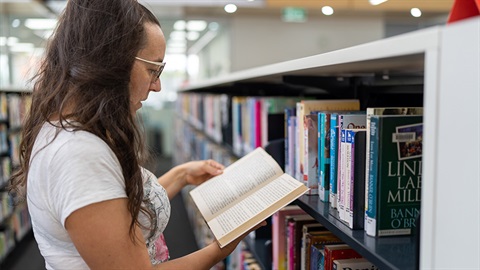 Resident-browsing-books-in-a-library.jpg