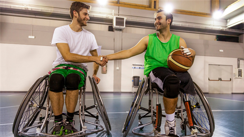 two indoor wheelchair basketball players