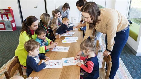 children with carers at table