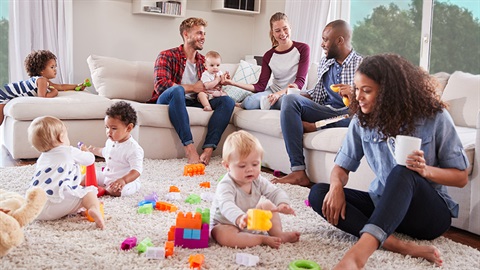 First-time parent group of mums dads and children getting together
