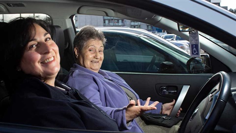 carer and older person in car