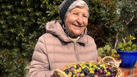 Lady with a basket of olives from her garden