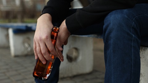 Man in park drinking alcohol