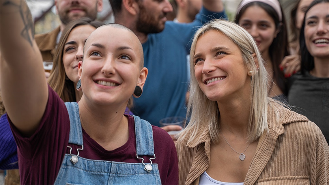 Two young people having fun at an outdoor concert