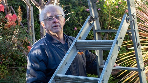 older man with ladder