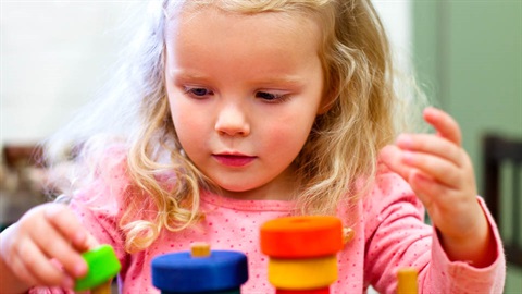 Young child playing with toy