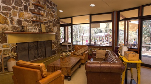 Couches and armchairs near an unlit fireplace