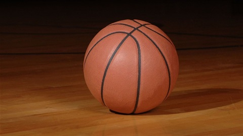 Orange basketball on stadium floor