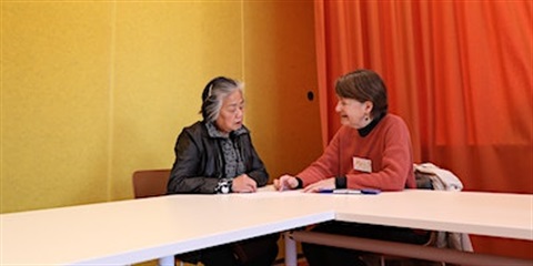 two people sitting at table