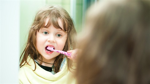 Young girl brushing her teeth