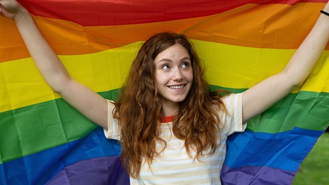 Young woman with an IDAHOBIT flag