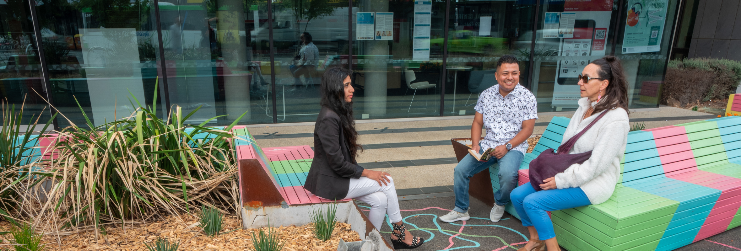 Banner of people talking sitting on park benches.png