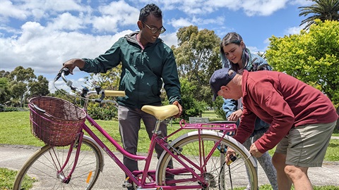 People checking the tires of a bicycle