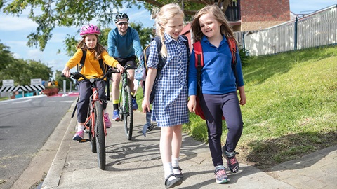 School children and cyclists on a footpath