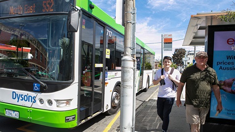 Two people who have just got off a bus