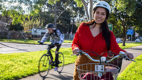 Pedestrians, cyclist, train and parked cars