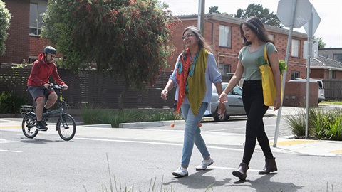 Two pedestrians crossing a street