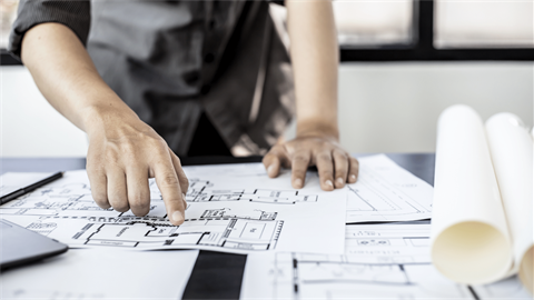 Person looking at building plans.png