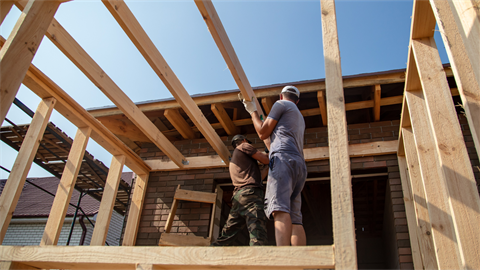 Two people building structure