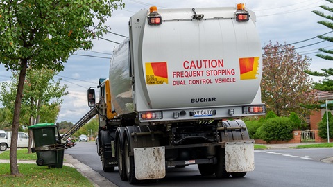 Food and green waste bin being emptied by a truck