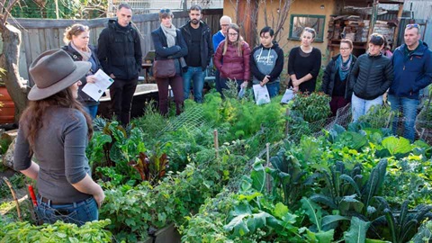 educator talking to group in garden