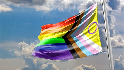 A rainbow flag with a yellow-and-purple intersex symbol, and stripes of blue, pink, white, brown and black for the trans community and LGBTIQ people of colour