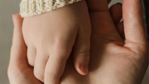 Parents and young child hands