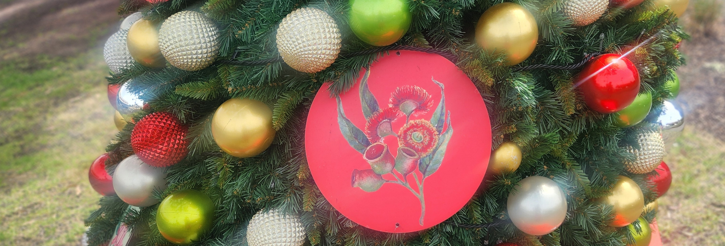 Close up of christmas tree with bright coloured baubles